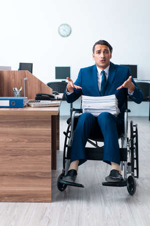 Young male employee in wheel-chairの写真素材