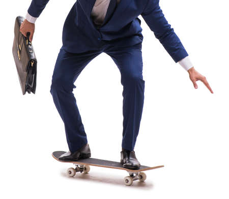 The businessman riding skateboard isolated on white backgroundの写真素材
