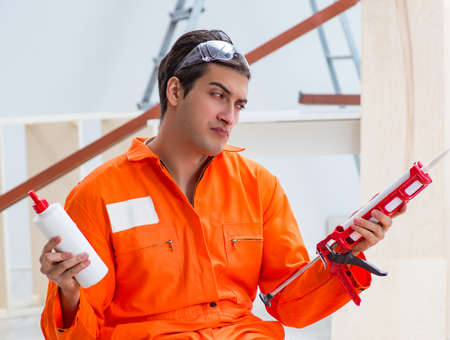 Contractor working on laminate wooden floor