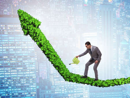 The businessman in investment concept watering financial line chの写真素材