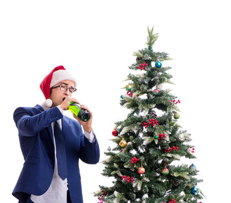 Businessman decorating christmas tree isolated on whiteの写真素材