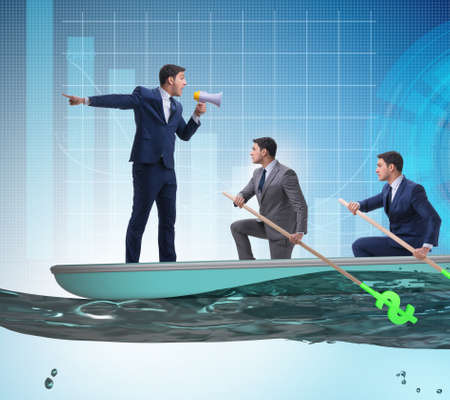 Team of businessmen in teamwork concept with boatの写真素材