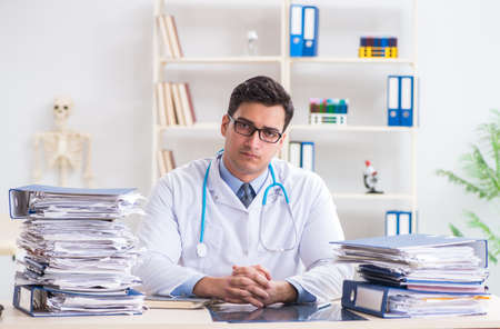 Busy doctor with too much work in hospitalの写真素材
