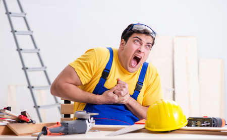 Floor repairman disappointed with his workの写真素材