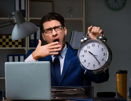 Businessman falling asleep during long hours in officeの写真素材