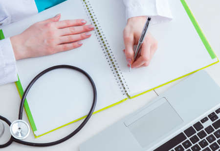 Hand writing medical prescription in computerの写真素材