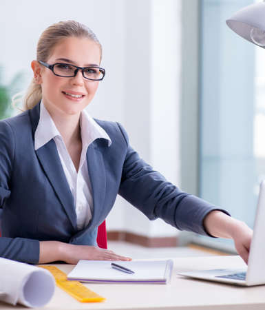 Businesswoman working at her desk in officeの写真素材