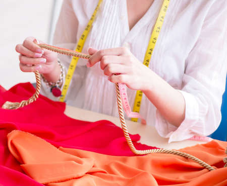 Woman tailor working on new dress designsの写真素材
