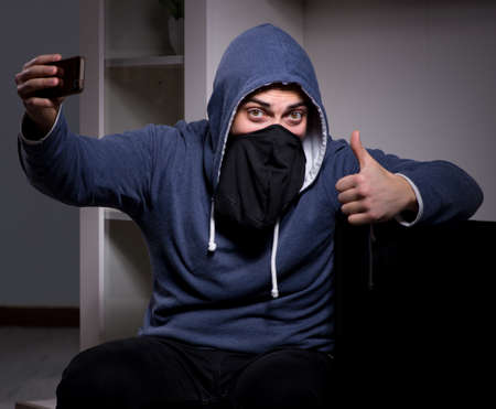 Burglar thief stealing tv from apartment house