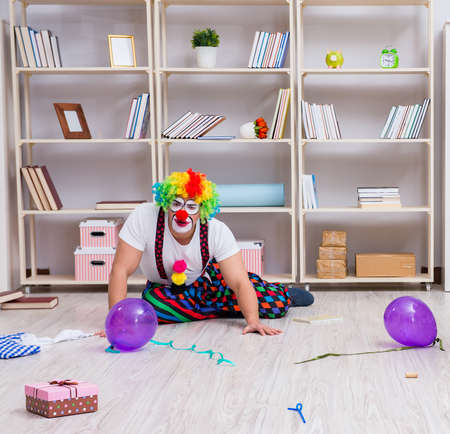 Drunk clown celebrating having a party at homeの写真素材