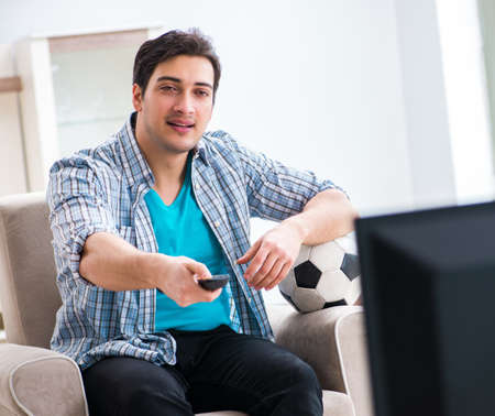 Man watching tv at homeの写真素材