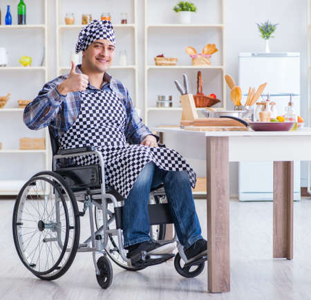 Disabled young man husband working in kitchenの写真素材