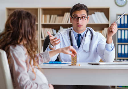 Pregnant woman visiting doctor for consultationの写真素材