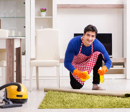 Contractor man cleaning house doing choresの写真素材