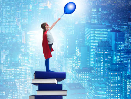 Superhero little girl in education conceptの写真素材