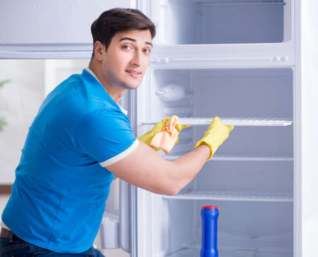 Man cleaning fridge in hygiene conceptの写真素材
