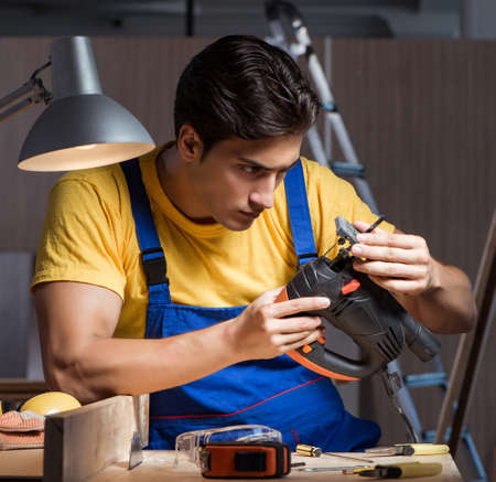 The worker working in repair workshop in woodworking conceptの写真素材