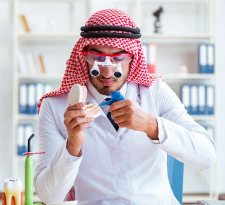 Arab dentist working on new teeth implantの写真素材