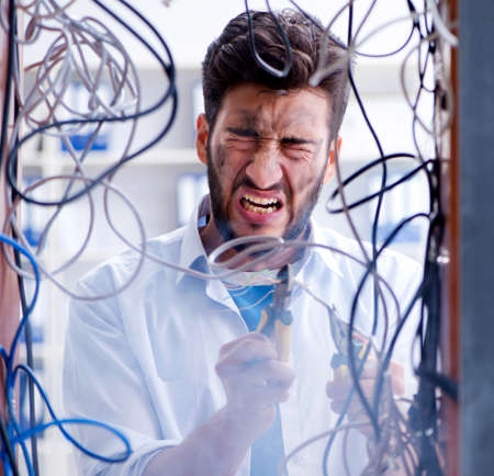Electrician trying to untangle wires in repair conceptの写真素材