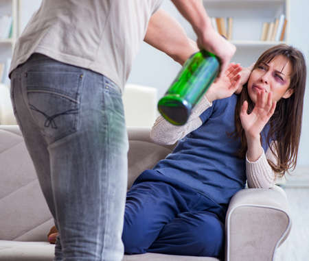 Drunk husband abusing wife in domestic violence conceptの写真素材
