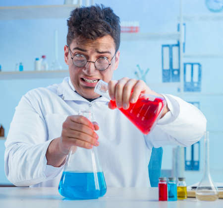 Funny mad chemist working in a laboratory
