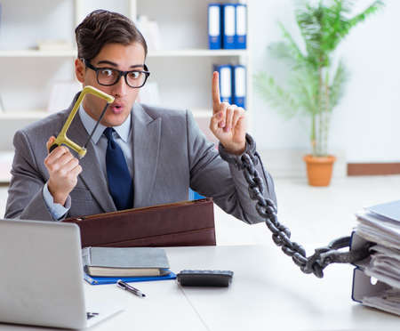 Busy employee chained to his office desk