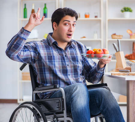 Young disabled husband preparing food saladの写真素材