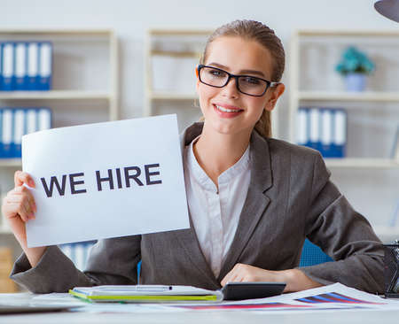 Businesswoman sitting in office with messageの写真素材