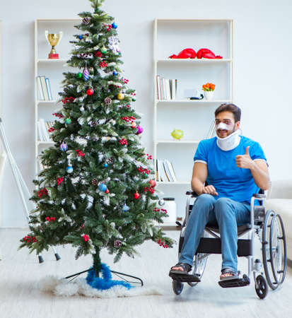 Injured disabled man celebrating christmas at homeの写真素材