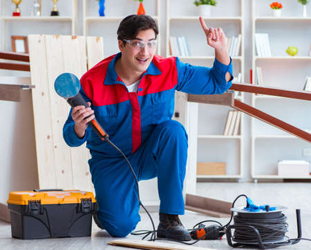 Young carpenter working with wooden planksの写真素材