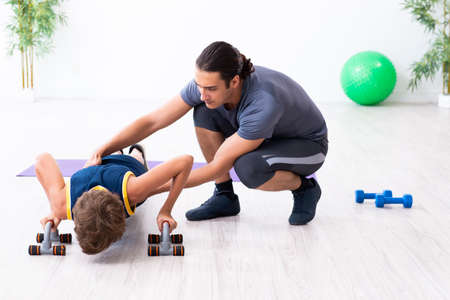 Young father and his son doing exercisesの写真素材