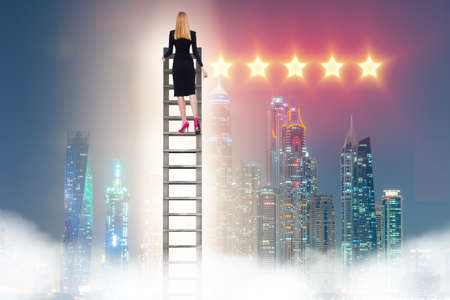 Businesswoman reaching out for stars in success conceptの写真素材
