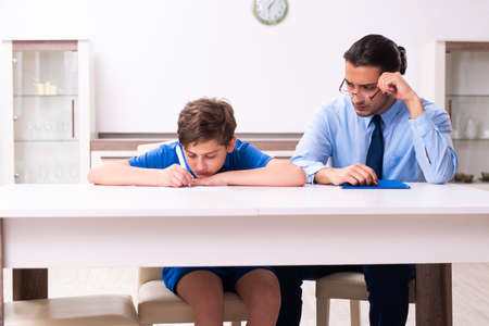 Busy father helping his son to prepare for examの写真素材