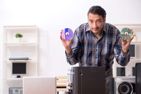 Young engineer repairing musical hi-fi systemの写真素材