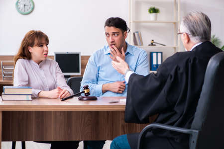 Young couple in the courthouse in divorce conceptの写真素材