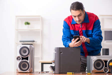 Young engineer repairing musical hi-fi systemの写真素材