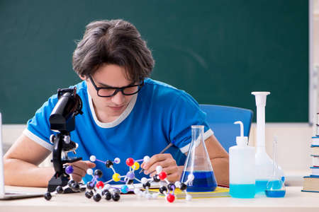 Young male student in the classroom