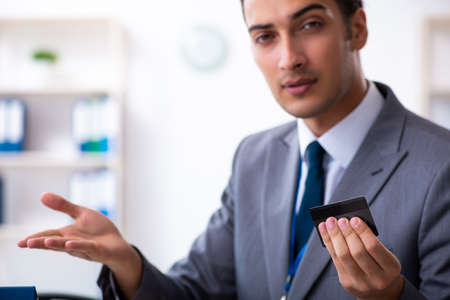 Young male accountant working in the officeの写真素材