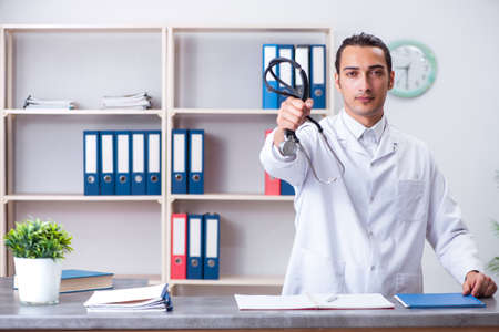 Young male doctor at the reception in the hospitalの写真素材