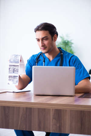 Young male doctor looking at doppler imagesの写真素材