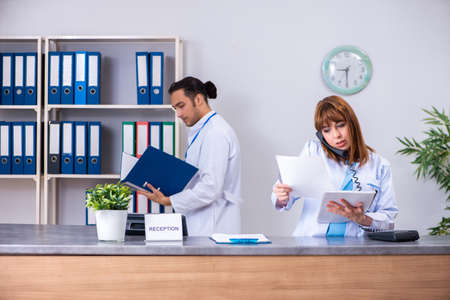 Two doctors working at the reception in the hospitalの写真素材