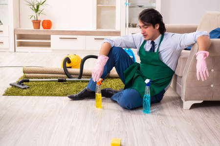 Young businessman cleaning the houseの写真素材