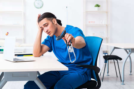Young male doctor working in the clinicの写真素材