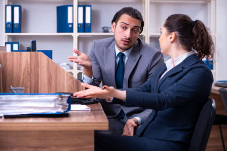 Two employees working in the officeの写真素材