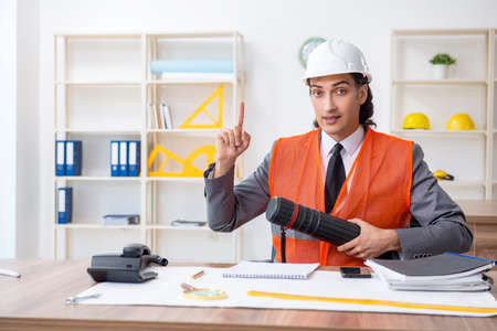 Young male architect working in the office