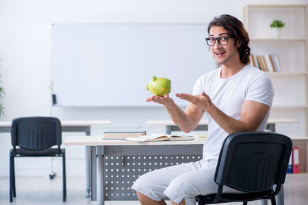 Young male student in front of whiteboardの写真素材