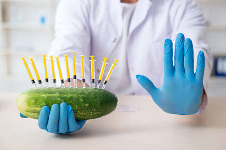 Male nutrition expert testing vegetables in lab