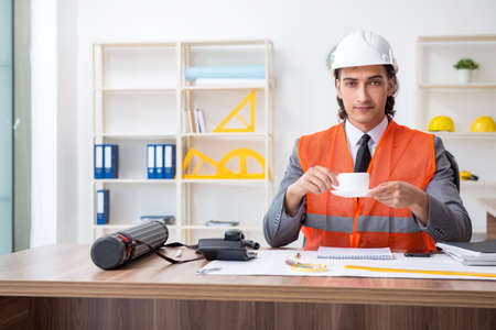 Young male architect working in the office