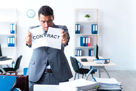 Businessman with heavy paperwork workloadの写真素材