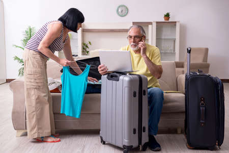 Old couple preparing for vacation travelの写真素材